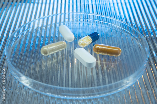 Color medicine pills on blue laboratory table