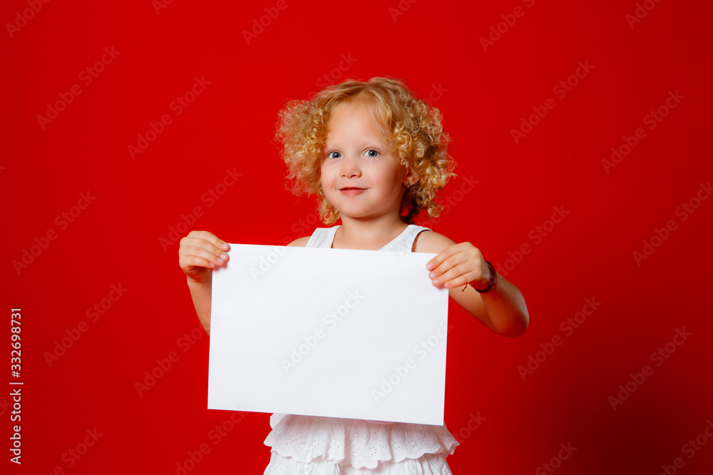 Cute little girl isolated on red holding blank paper Cute little girl isolated on red holding blank paper