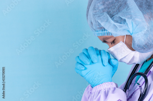 The doctor is praying to God requesting that the coronavirus covid-19 not spread beyond control. Coronavirus or Covid-19 breakout concept.
