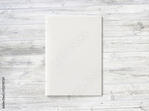 Blank Magazine or Brochure on wooden background. Front cover top view as mockup template for your design presentation