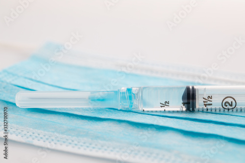 Plastic Syringe and medical mask . covid-19 , Coronavirus pandemic , Coronavirus disease.