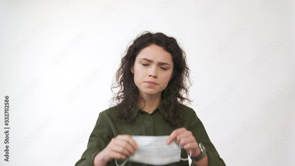 Young woman coughing. Wearing medical mask looking at camera. isolated on white  background. Close up front portrait. Health concept. 4k