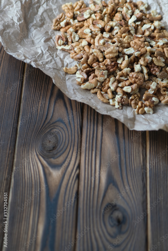 Fototapeta premium Walnuts on dark wooden background