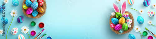 Photo Easter poster background template with Easter eggs in the nest on light blue background