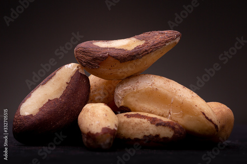 Evenly lit grouping of chestnut low key still life contrasted against a dark gray background