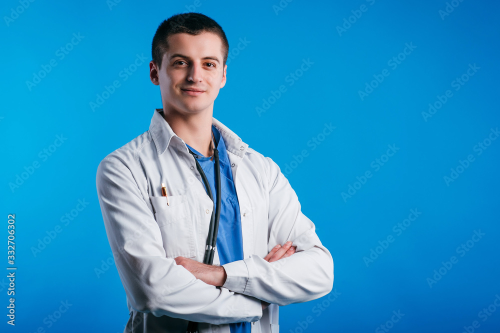Portrait of young smiling doctor with stethoscope isolated on blue background Portrait of young smiling doctor with stethoscope isolated on blue background
