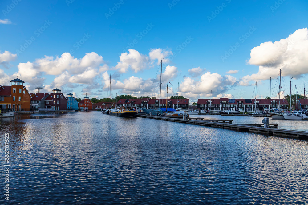 Port in Groningen city in Holland. The background is a blue sky with white clouds.