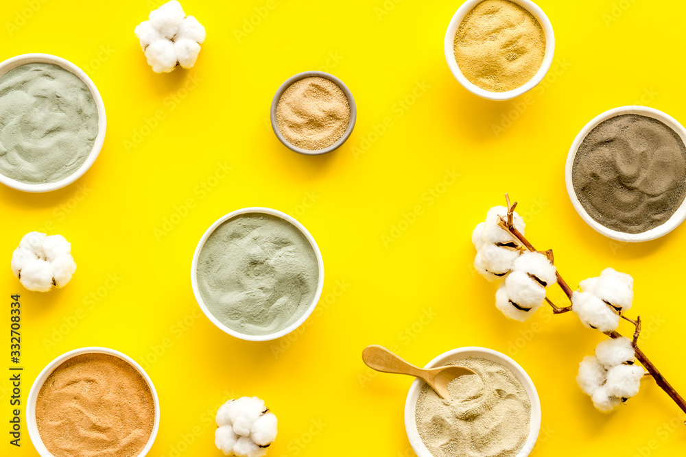Blue, yellow, white. red, black cosmetic clay background on yellow table top-down Blue, yellow, white. red, black cosmetic clay background on yellow table top-down