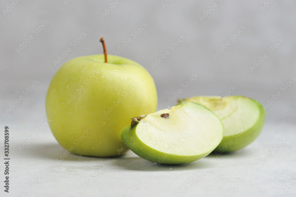 one whole and cut green Apple