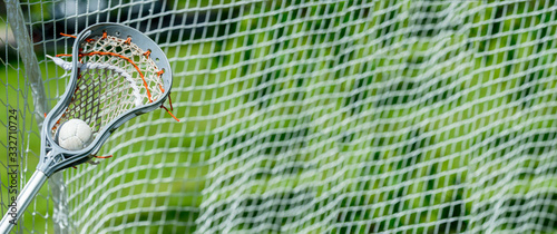 Abstract view of a lacrosse stick scooping up a ball photo