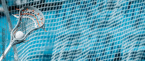Fotografie Abstract view of a lacrosse stick scooping up a ball. Blue filter