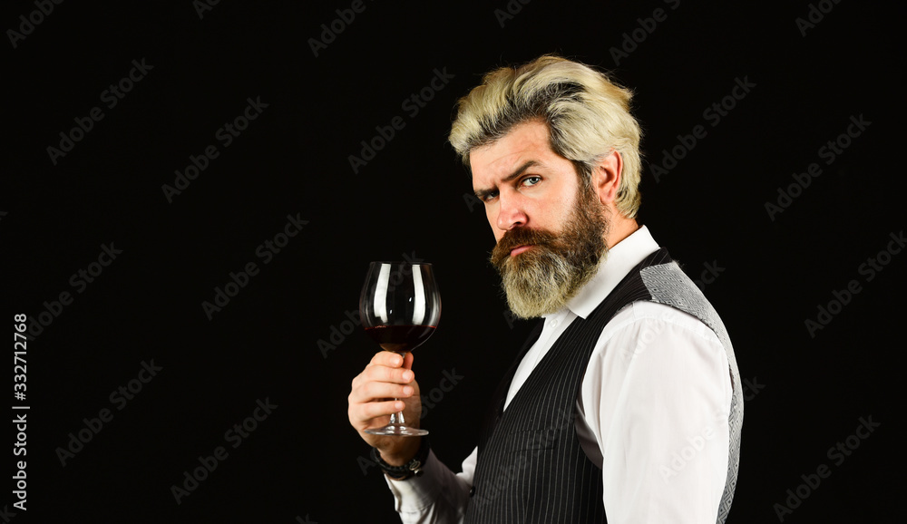 male sommelier appreciating drink. glass of red wine. Bartender at wine cellar with exquisite drink. experienced sommelier taste wine. barman tasting red wine at degustation. copy space