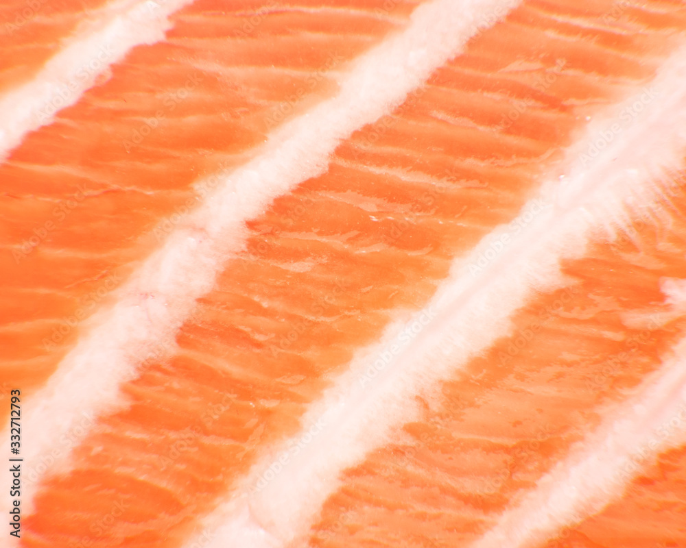 MEXICO CITY, MEXICO - FEBRUARY 03, 2019. Closeup view of a slice of fresh salmon. Commonly served as sashimi and sushi dishes in japanese cusine. MEXICO CITY, MEXICO - FEBRUARY 03, 2019. Closeup view of a slice of fresh salmon. Commonly served as sashimi and sushi dishes in japanese cusine.