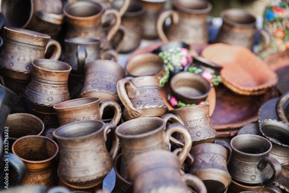 Handmade clay brown pots on a blurred background