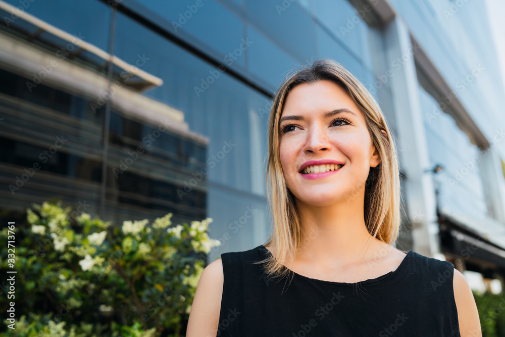 Business woman standing outside office buildings. Business woman standing outside office buildings.
