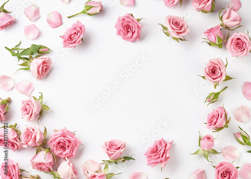 Rose flowers on white background with copy space for design, text. Top view of pink roses and rose buds. photo