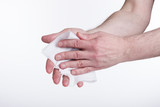 Human hands use a wet wipe close-up on a white background. Concept of infection.