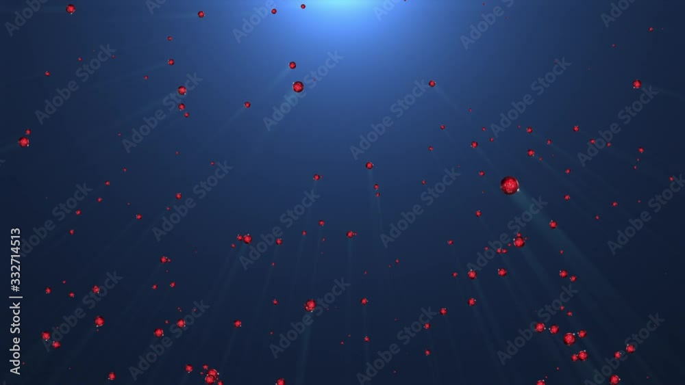 Red Christmas ornaments falling under bright light Red Christmas ornaments falling under bright light