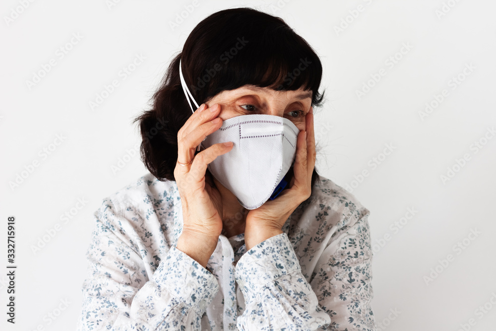 Coronavirus quarantine Covid-19 concept. Face of old sick woman wearing respirator mask for protect. Wuhan, China epidemic virus symptoms background. Coronavirus quarantine Covid-19 concept. Face of old sick woman wearing respirator mask for protect. Wuhan, China epidemic virus symptoms background.