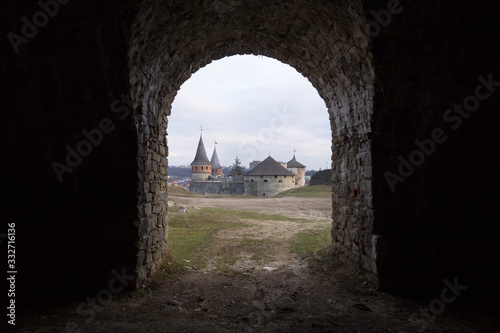 View of the Kamyanets-Podilsky fortress from the arch of stone fortifications around the castle