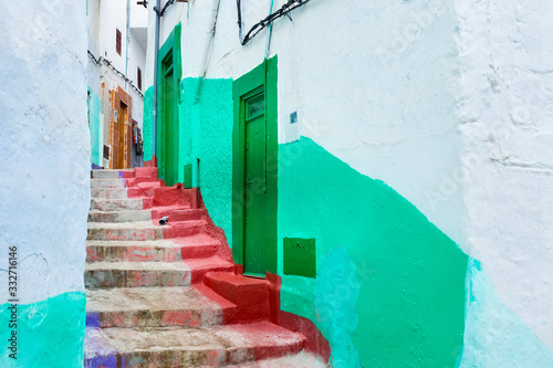 View of the colorful old walls of Tetouan Medina quarter in Northern Morocco. A medina is typically walled, with many narrow and maze-like streets and often contain historical houses, palaces, places. © Renar