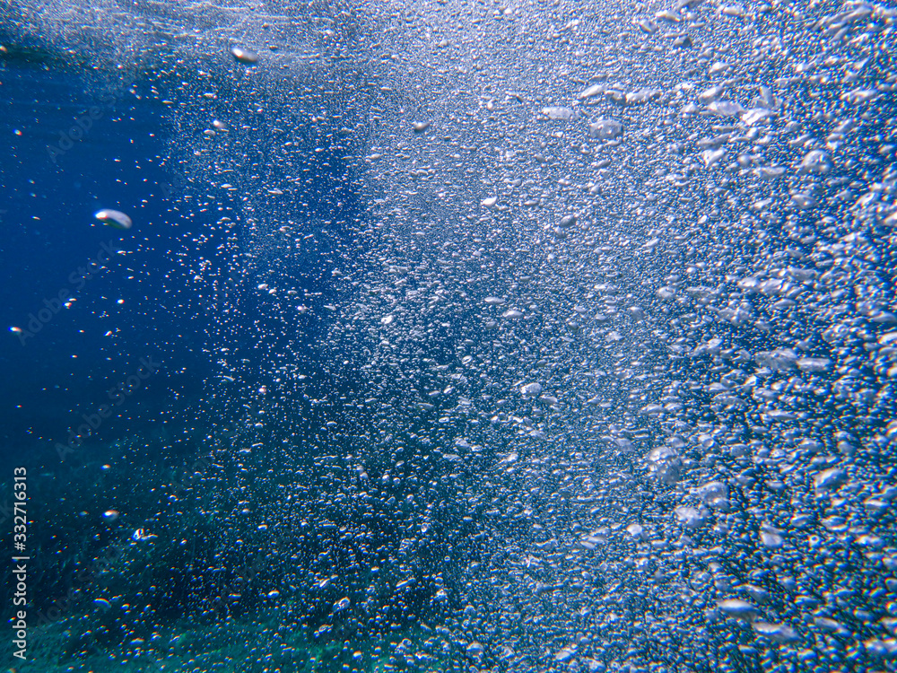 Air bubbles in blue water - underwater life off the Kastos island coast, Ionian Sea, Greece - abstract background. Air bubbles in blue water - underwater life off the Kastos island coast, Ionian Sea, Greece - abstract background.