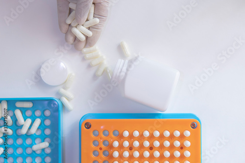 Photography White pill capsules in hand wearing white medical gloves
