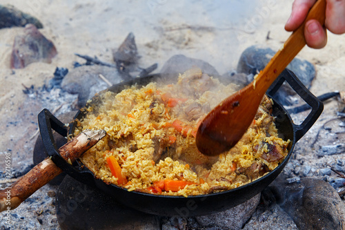 Traditional pilaf with lamb preparated on the fire. photo