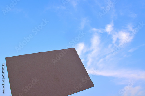 Brown paper on a sky background with white clouds