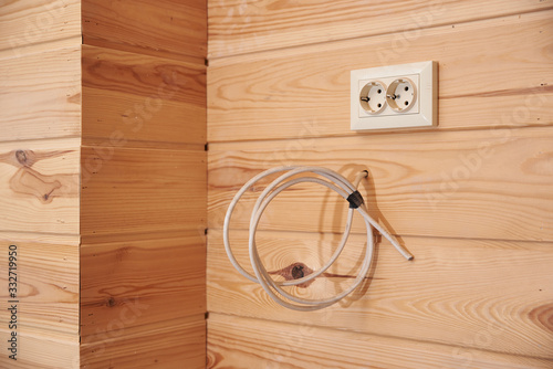 Electrical outlet and wires for connection on a wooden wall