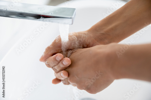 Female wash hands removes dirt, kills microbes flush antibacterial agent under flowing water from tap close up view. Stop 2019-ncov corona virus outbreak, personal hygiene, health care routine concept