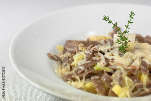 Pizzoccheri, a typical Italian pasta dish with cheese on white background