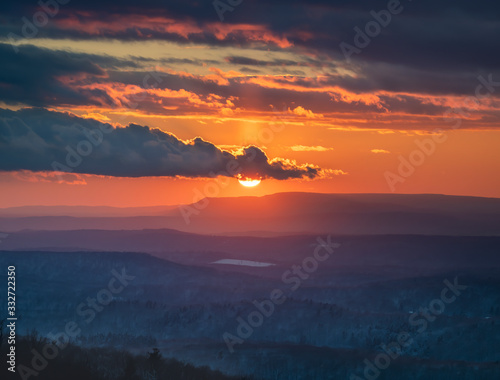 Brilliant Orange Sunset with Moody Dark Clouds, Hudson Valley, NY photo