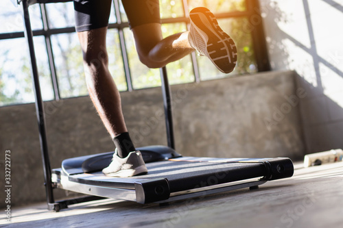 Young men exercise on an automatic treadmill