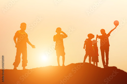 silhouette of a happy children and happy time sunset