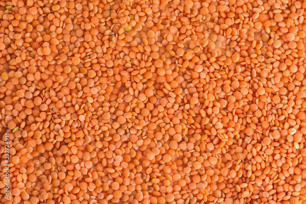 Texture red lentils background pattern top view. Healthy source of protein nutrition. Vegetarian-based vegan diet. Emergency stocks - background. Organic ingredient for healthy soups. Texture red lentils background pattern top view. Healthy source of protein nutrition. Vegetarian-based vegan diet. Emergency stocks - background. Organic ingredient for healthy soups.