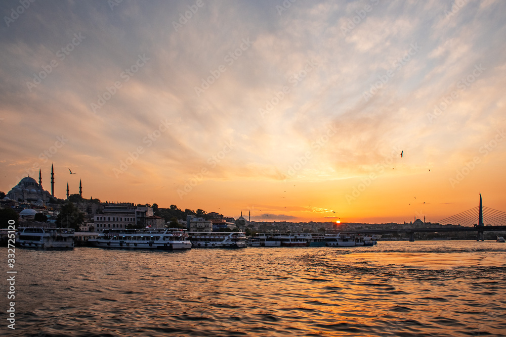 summer Sunny landscape in Istanbul on the sunset.  Strait through the Bosphorus with a view of the blue mosque. A ship with tourists sails under the bridge