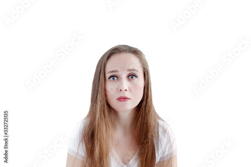 Sad young caucasian woman with unhappy facial expression, isolated on white background, close-up portrait © dariazu