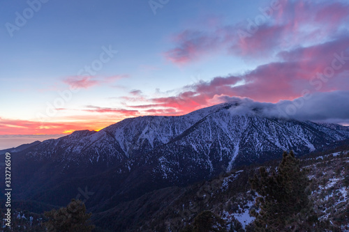 beautiful pink sunset in snowy mountains