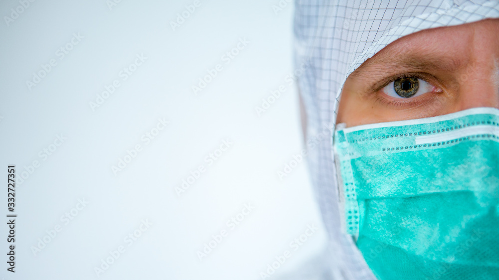 A close-up portrait of male caucasian doctor wearing a protective suit and mask A close-up portrait of male caucasian doctor wearing a protective suit and mask