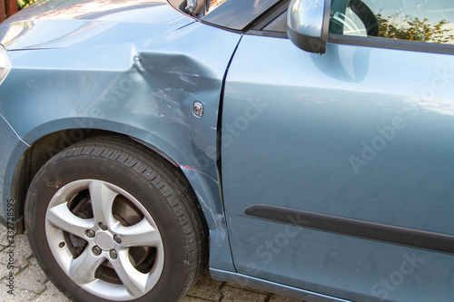 Wallpaper Mural small car in the color blue metallic with sheet metal damage to the body as a result of a traffic accident Torontodigital.ca