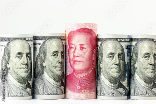 world strongest currency between China Yuan banknote and American US dollar bills represent economic war on white space background  