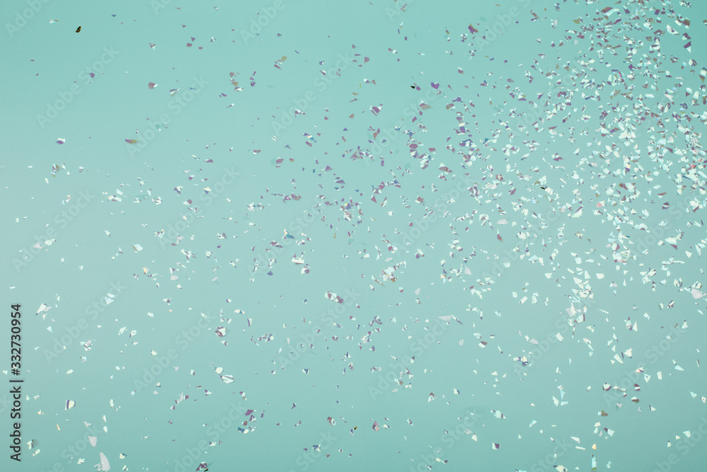 Holographic flying sparkles on blue festive background. Holiday backdrop for your projects. Holographic flying sparkles on blue festive background. Holiday backdrop for your projects.