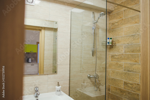 Modern en-suite bathroom with shower cabin, basin and mirror.