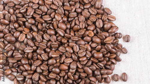 coffee beans.coffee beans sprinkled on fabric. © Ирина Бельдий