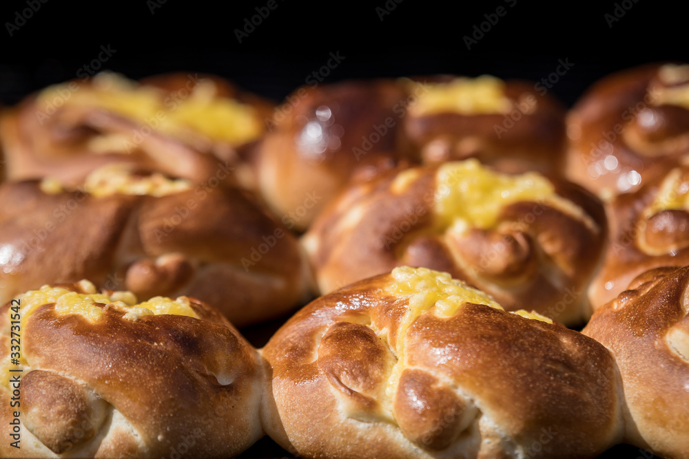 Freshly home backed cheese and vanilla buns, on display for sale at a street food market, top view or flat lay photo of healthy food photographed with selective focus