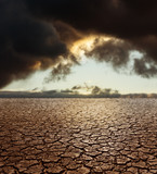 Drought Earth - Cracked Land with Stormy Sky on Background