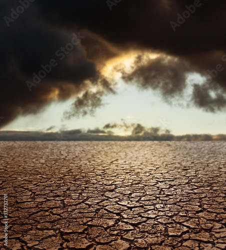 Drought Earth - Cracked Land with Stormy Sky on Background