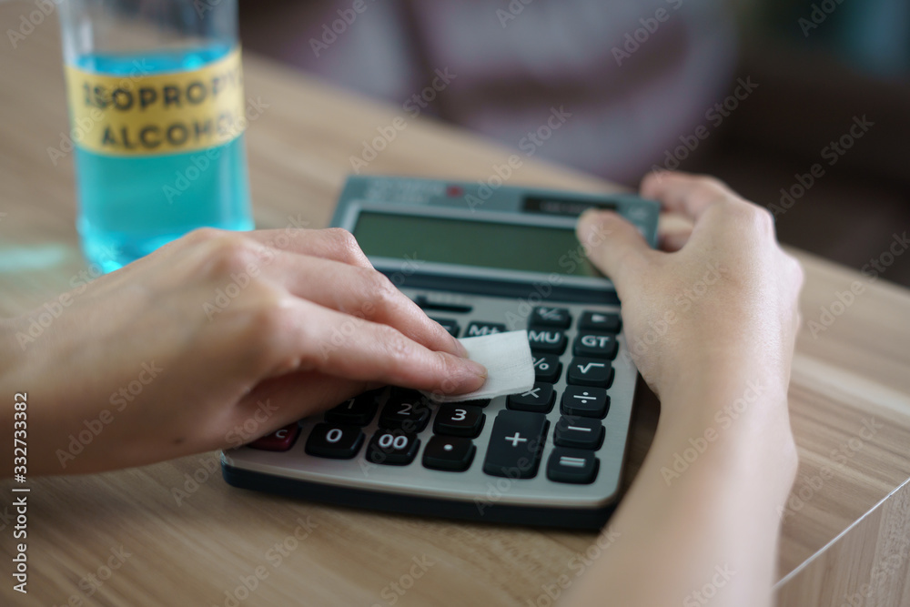 Female clean Calculator with Isopropyl alcohol for corona virus or Covid-19 protection. Female clean Calculator with Isopropyl alcohol for corona virus or Covid-19 protection.