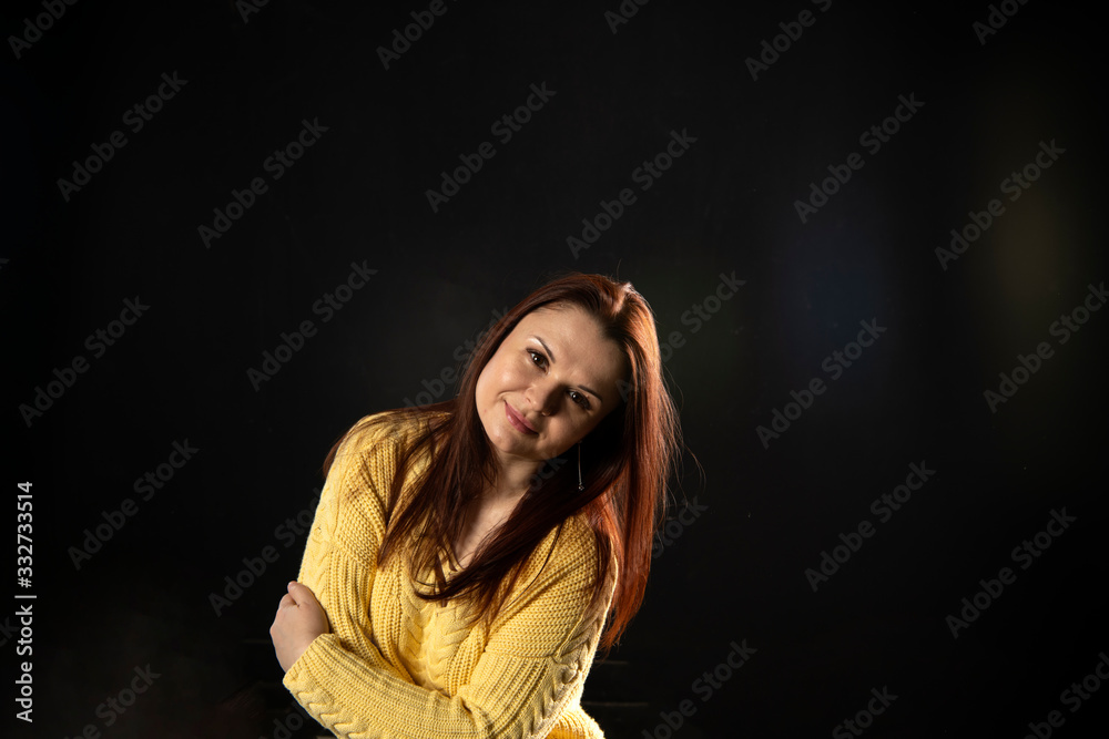 girl in yellow posing on a black background girl in yellow posing on a black background